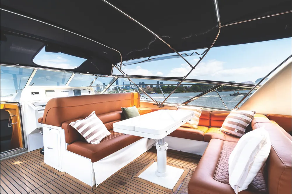 Aft deck lounge and table under the bimini on Bote