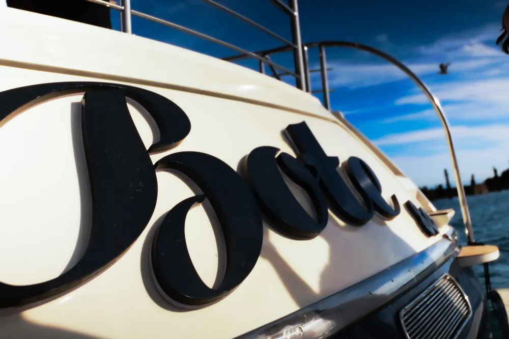 Bote name in black script on the white transom