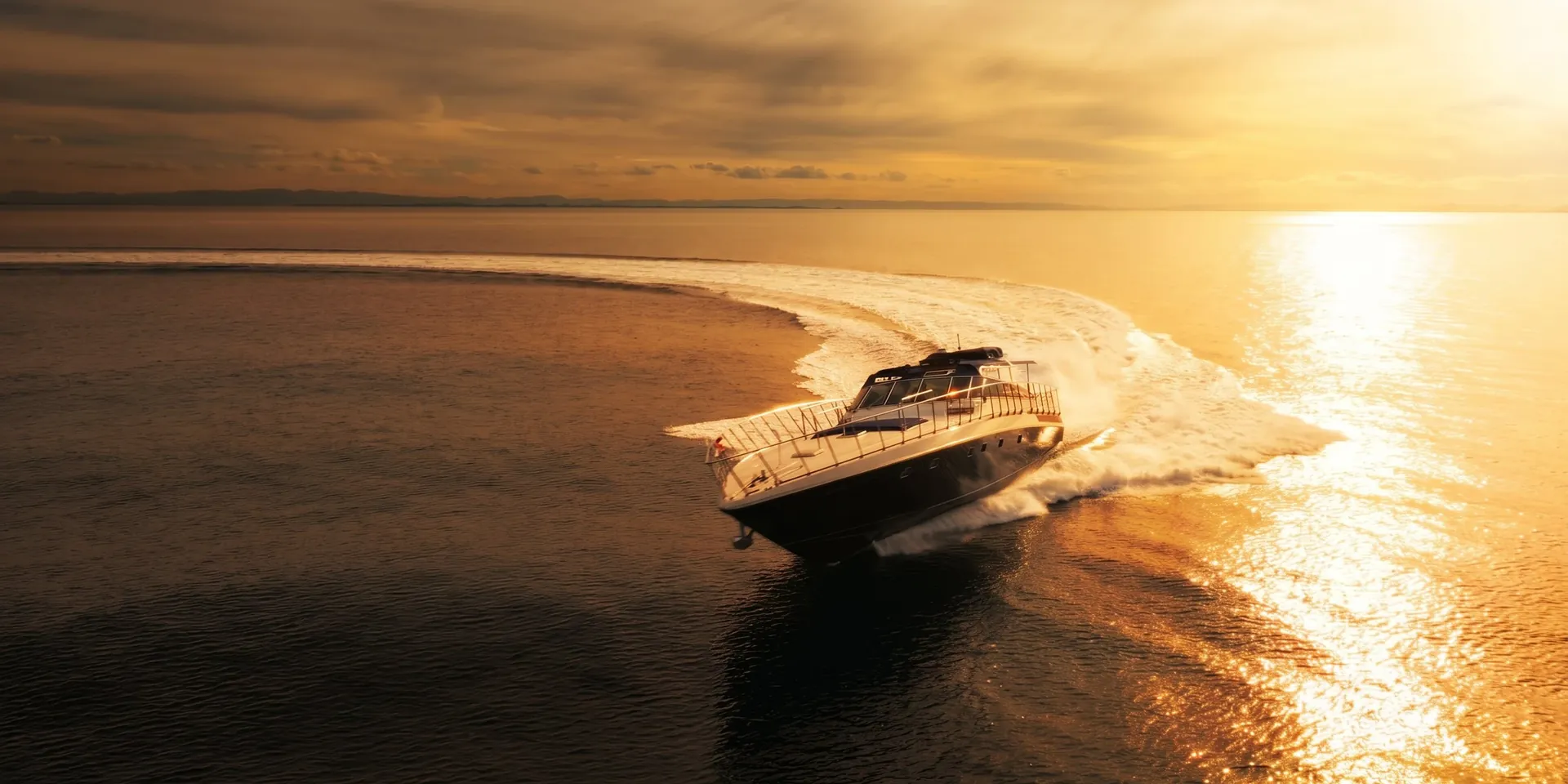 Bote at speed across golden water off the Gold Coast at sunset