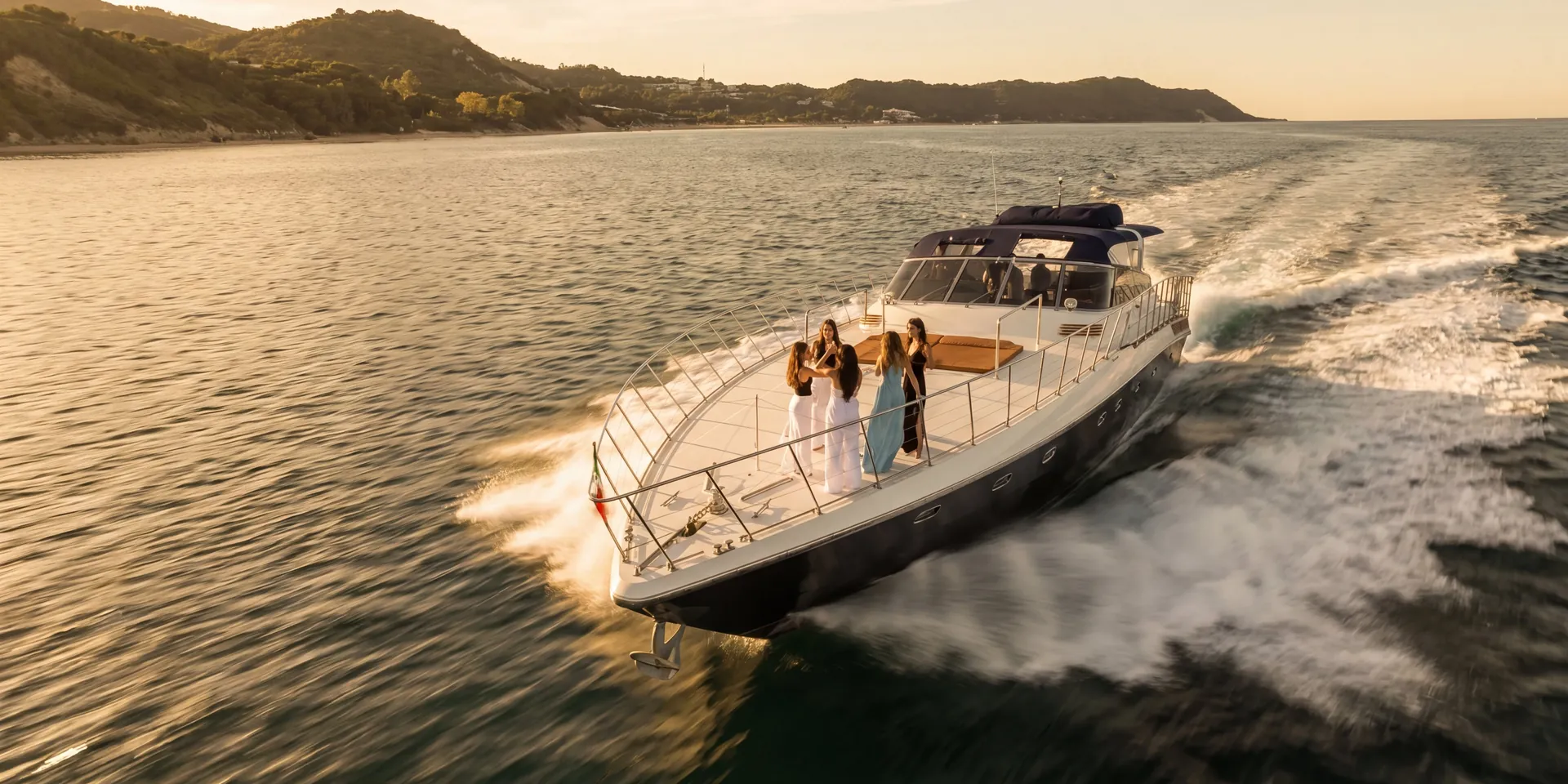 Bote, an 80 foot motor yacht, cruising at speed with guests on the bow off the Queensland coast