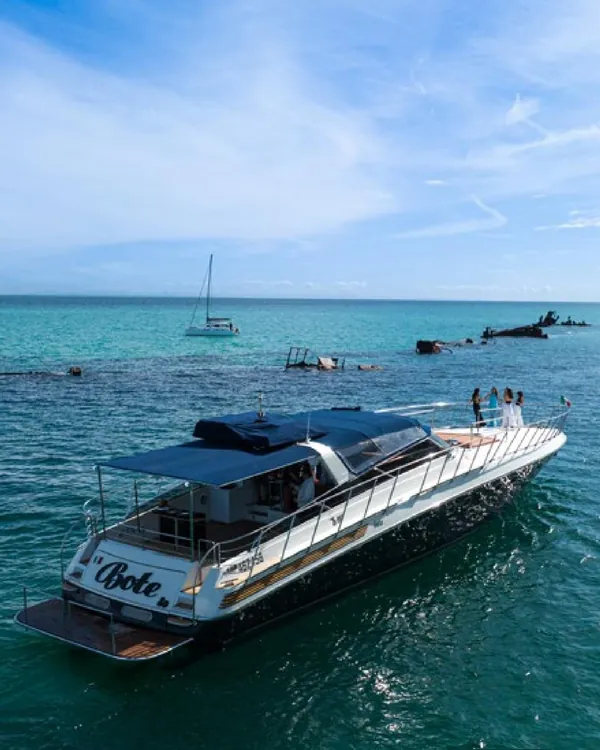 Bote anchored in turquoise water beside the Tangalooma wrecks, Moreton Island
